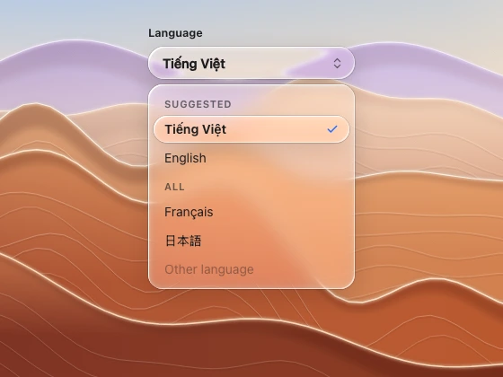 A language selector with its capsule trigger and an open grouped list with a checked option, over zoomed desert ridges.